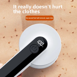 Rechargeable fabric shaver with LED digital display removing lint from a sweater
