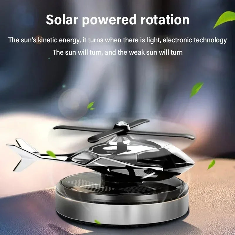 Solar helicopter car air freshener with rotating propeller on a car dashboard